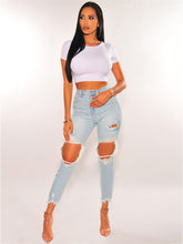 Vaqueros desgastados, ajustados, de cintura media y elásticos